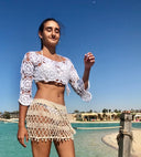 "Shell We Dance: Short Hand-Knitted Skirt with Dangling Shells"